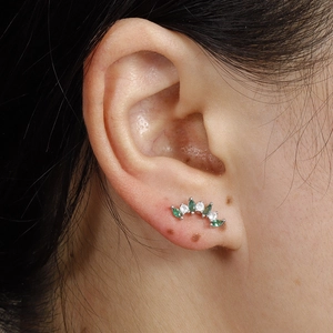 Silver stainless steel stud earring featuring green marquise gems and white zircons