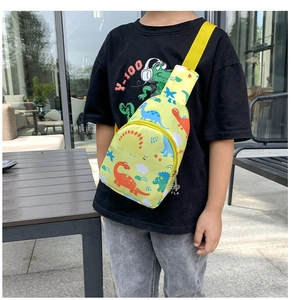Detailed view of yellow kids dinosaur chest bag featuring adjustable strap and nylon fabric