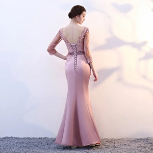 Detailed back view of mauve mermaid evening gown with lace appliques and corset lacing