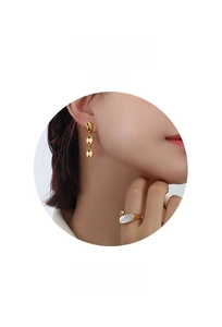 Macro detail of 18k gold plated earring with oval white mother of pearl inlay texture