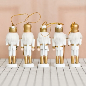 Five 13cm wooden nutcracker ornaments with gold accents and white hair on a plaid base