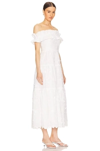Detail of white off-shoulder midi dress featuring 3D floral embroidery and lace ruffles