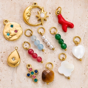 Detail of 18k gold plated stainless steel charms including heart and star shapes