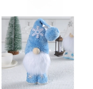 Close-up of blue plush Christmas gnome with snowflake embroidery and soft white beard