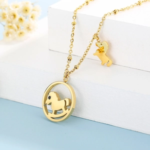 Detailed view of golden rocking horse pendant necklace on a clean white surface