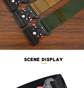 Three colors of tactical nylon belts with metal cobra buckles on a wooden background