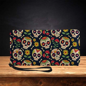 Long PU leather wallet with colorful sugar skull pattern and wristlet strap on wood