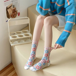 Detailed close-up of vintage embossed floral knit socks with blue and red patterns