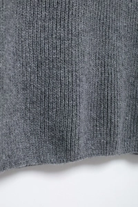 Détail rapproché du pull en maille gris avec texture à côtes verticales douces