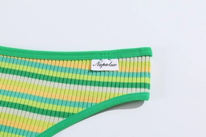 Macro detail of ribbed cotton thong showing colorful green and yellow horizontal stripes
