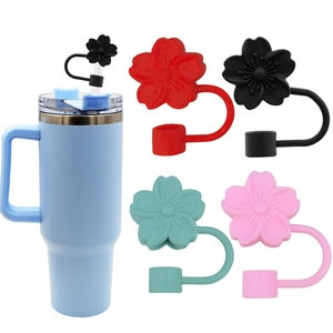 Detail view of colorful silicone flower straw covers in black, red, green and pink