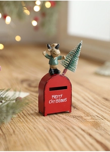 Miniature red metal Christmas mailbox with reindeer figurine and tiny tree on wood base