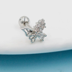 Macro detail of silver butterfly tragus stud with sparkling cubic zirconia and ball back