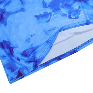 Detail showing the blue tie-dye print pattern and double-stitch hem on the long dress
