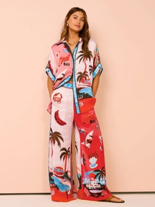 Detail of satin-finish tropical print summer set featuring short-sleeve shirt and wide-leg pants