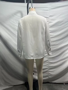 Detailed back view of a white satin long-sleeve shirt with elegant buttoned cuffs