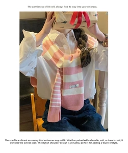 Detailed knit texture of pink and white striped shawl draped over a white shirt