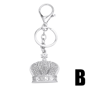 Silver crown keychain with sparkling rhinestones and KING engraved charm on white background