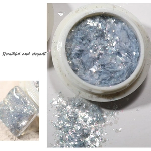 Blue opal aurora foil flakes for nail art in a round container with shimmering finish