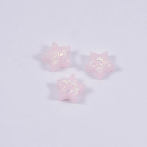 Three pink pentagon star resin opal beads with iridescent sequins on white background