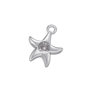 Macro shot of a silver star charm pendant with a clear zircon inlay and metal bail
