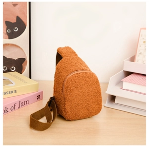 Macro detail of brown plush fleece material and zipper on the kids mini crossbody bag