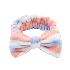 Pink and purple striped coral fleece headband with large bow detail for face washing