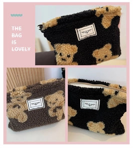 Close-up of fluffy sherpa makeup bag with teddy bear pattern and metal zipper detail