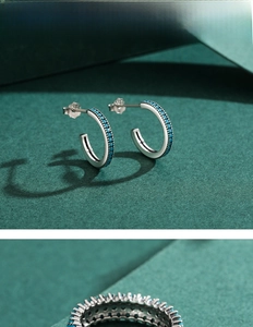 Macro detail of 925 silver C-shape stud earrings featuring turquoise blue beads in retro style