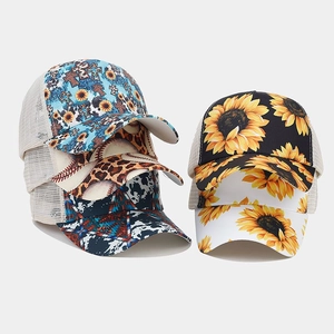 Detail of printed baseball caps with sunflower and leopard patterns and breathable mesh back