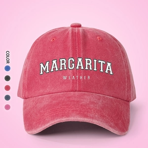 Detail of pink washed cotton baseball cap featuring Margarita Weather embroidery and color swatches