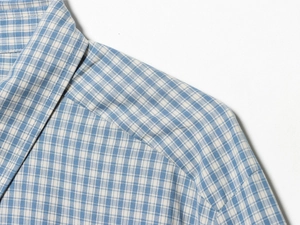 Close-up of the collar stitching on a blue and white slim fit plaid shirt