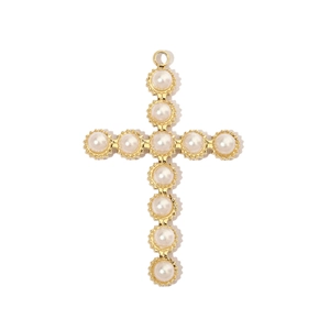 Detail of a gold stainless steel cross pendant featuring inlaid white pearls and sun motifs