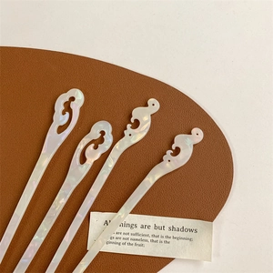 Set of 4 modern shell hair sticks with cloud pattern design on white background
