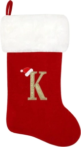 Detail of red velvet Christmas stocking with gold embroidered letter K and fur cuff