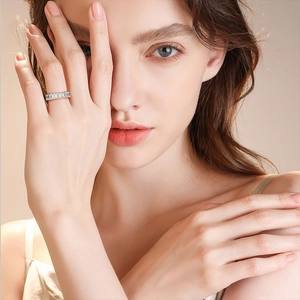 Close-up of 925 sterling silver ring with rectangular carbon diamonds on a model's finger