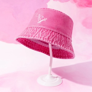 Detail of pink washed cotton bucket hat with white skull skateboarder print