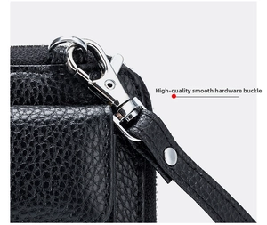 Detail of high-quality silver metal hook and black lychee grain leather wristlet strap