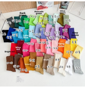 Flat lay of ribbed cotton mid-calf socks in 48 vibrant candy colors for women