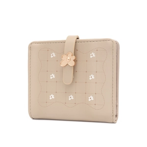 Macro detail of beige PU leather wallet with floral prints and flower metal buckle clasp