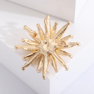 Macro view showing the back pin mechanism and golden metal texture of the sunflower brooch