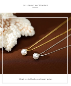 Close-up of minimalist gold and silver chains with round white pearl pendants