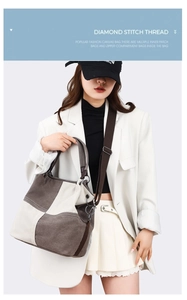 Detail view of canvas tote bag showing adjustable strap and stitching on white blazer model