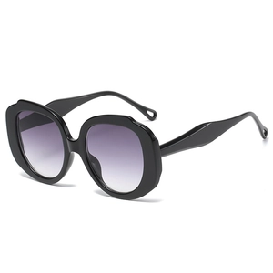 Fashionable oversized round sunglasses with black wavy frames and purple gradient lenses