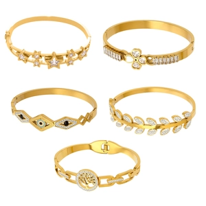 Set of five gold-plated bangles featuring star, clover, and evil eye cubic zirconia motifs