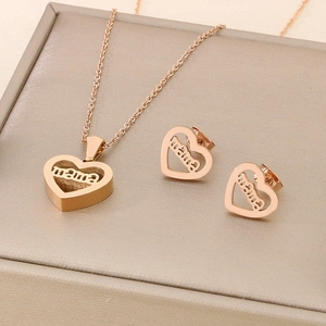 Macro shot of rose gold heart pendant and earrings set with engraved MAMA text