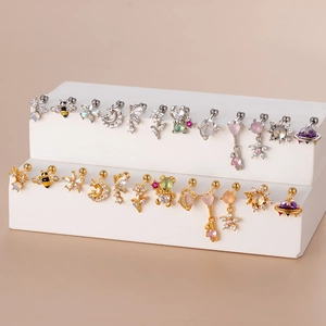Minimalist stainless steel stud earrings with gold and silver zircon charms set on display