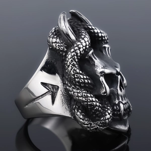 Detailed macro view of vintage silver skull and snake relief on stainless steel ring
