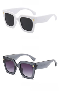 Detail view of square oversized sunglasses with chic gold metal temple accents
