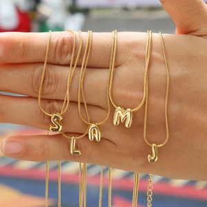 Golden balloon style initial letter pendants on sleek snake chains for women